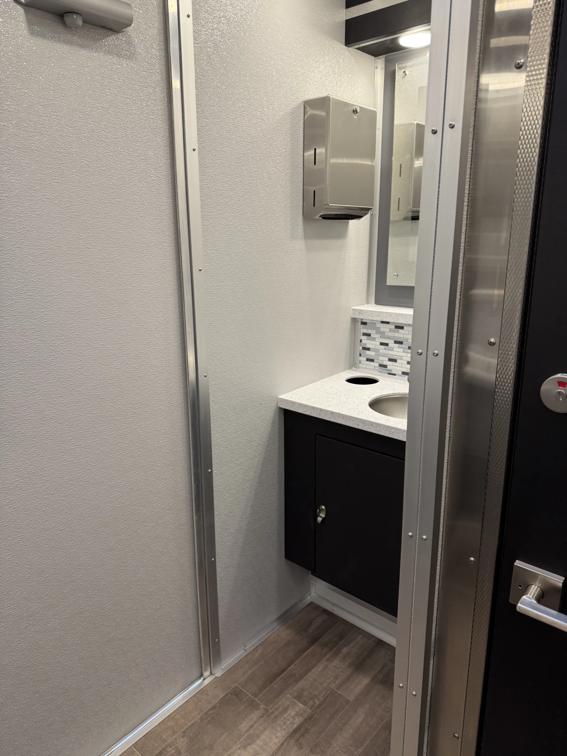 Portable restroom trailer setup at outdoor event in Newark