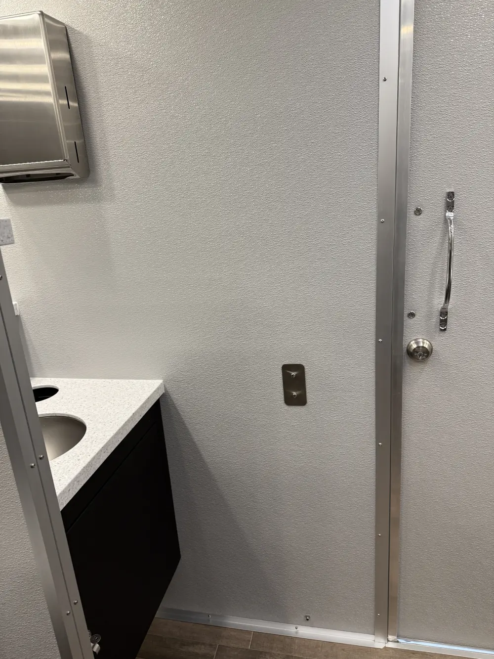 Portable restroom trailer setup at outdoor event in Newark