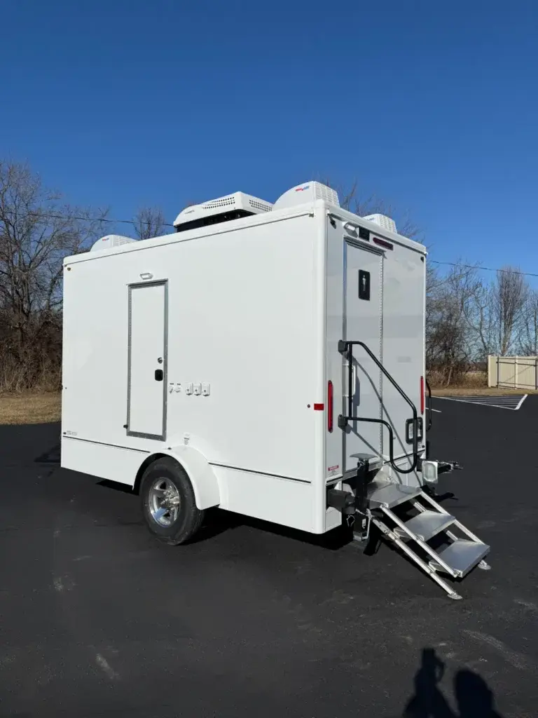 White luxury restroom trailer rental in a New Jersey parking lot.