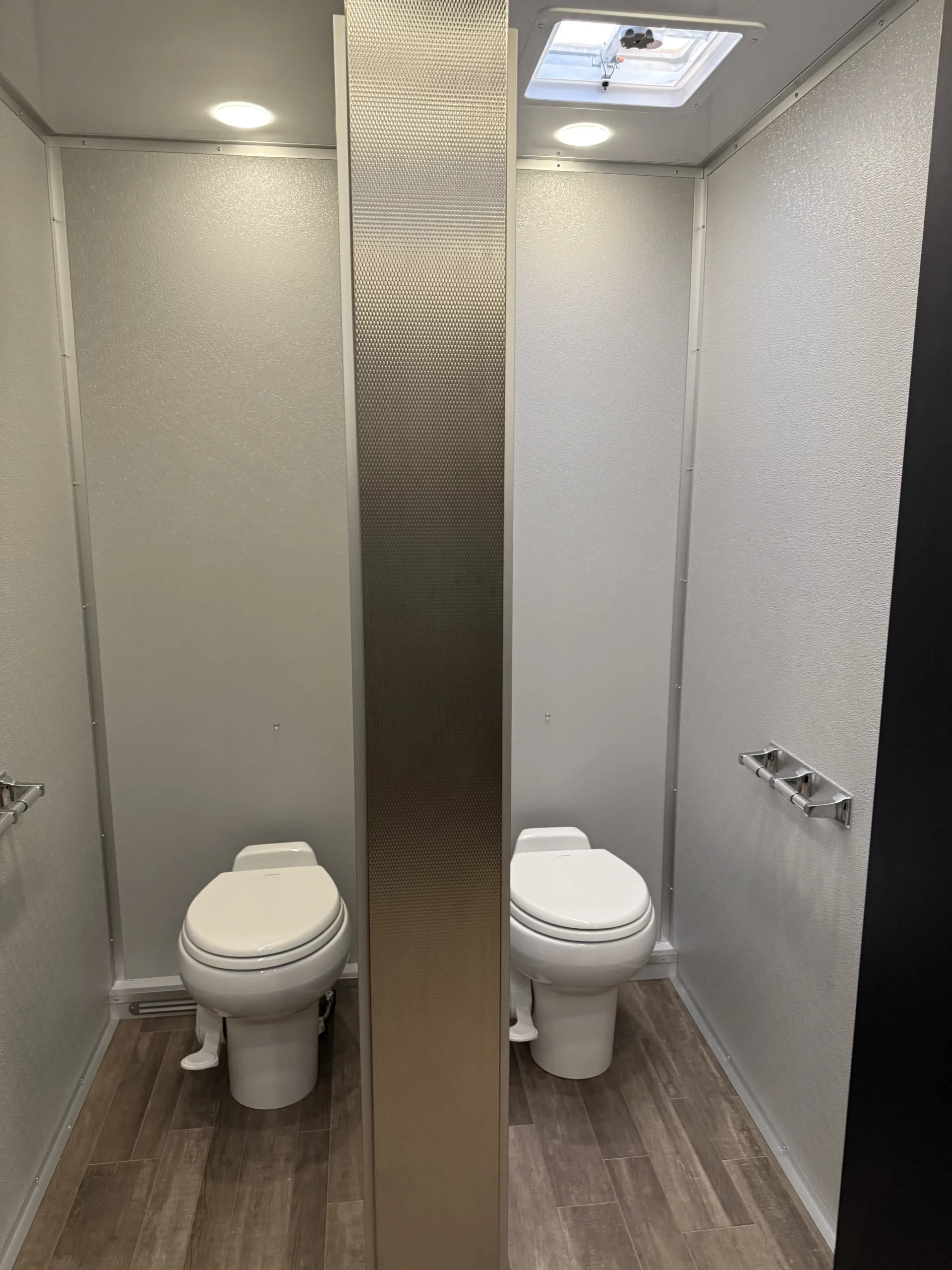 Portable restroom trailer setup at outdoor event in Newark