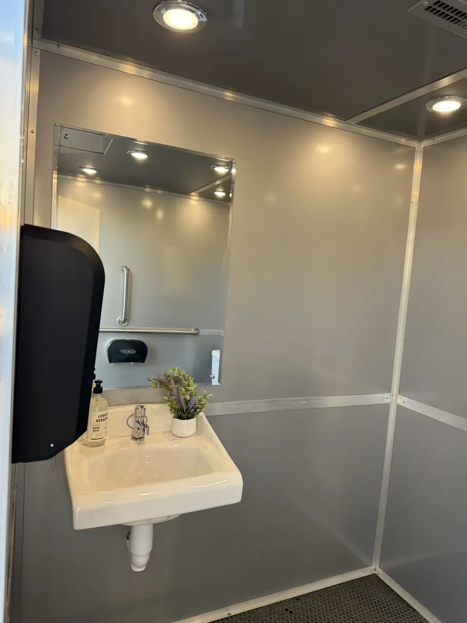 Portable restroom trailer setup at outdoor event in Newark