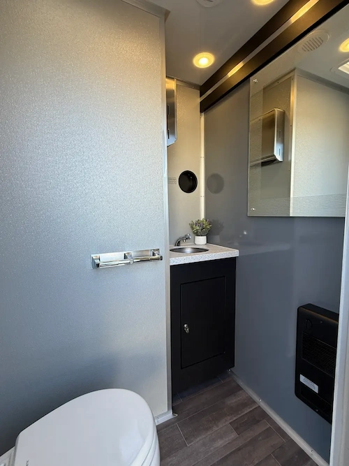 Portable restroom trailer setup at outdoor event in Newark