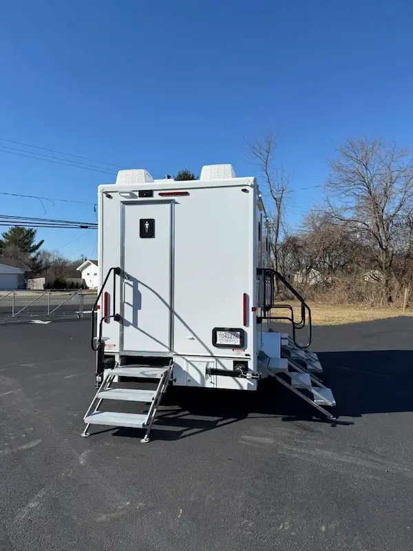 Portable restroom trailer setup at outdoor event in Newark