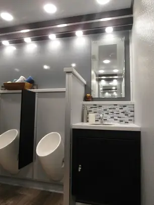 Portable restroom trailer setup at outdoor event in Newark